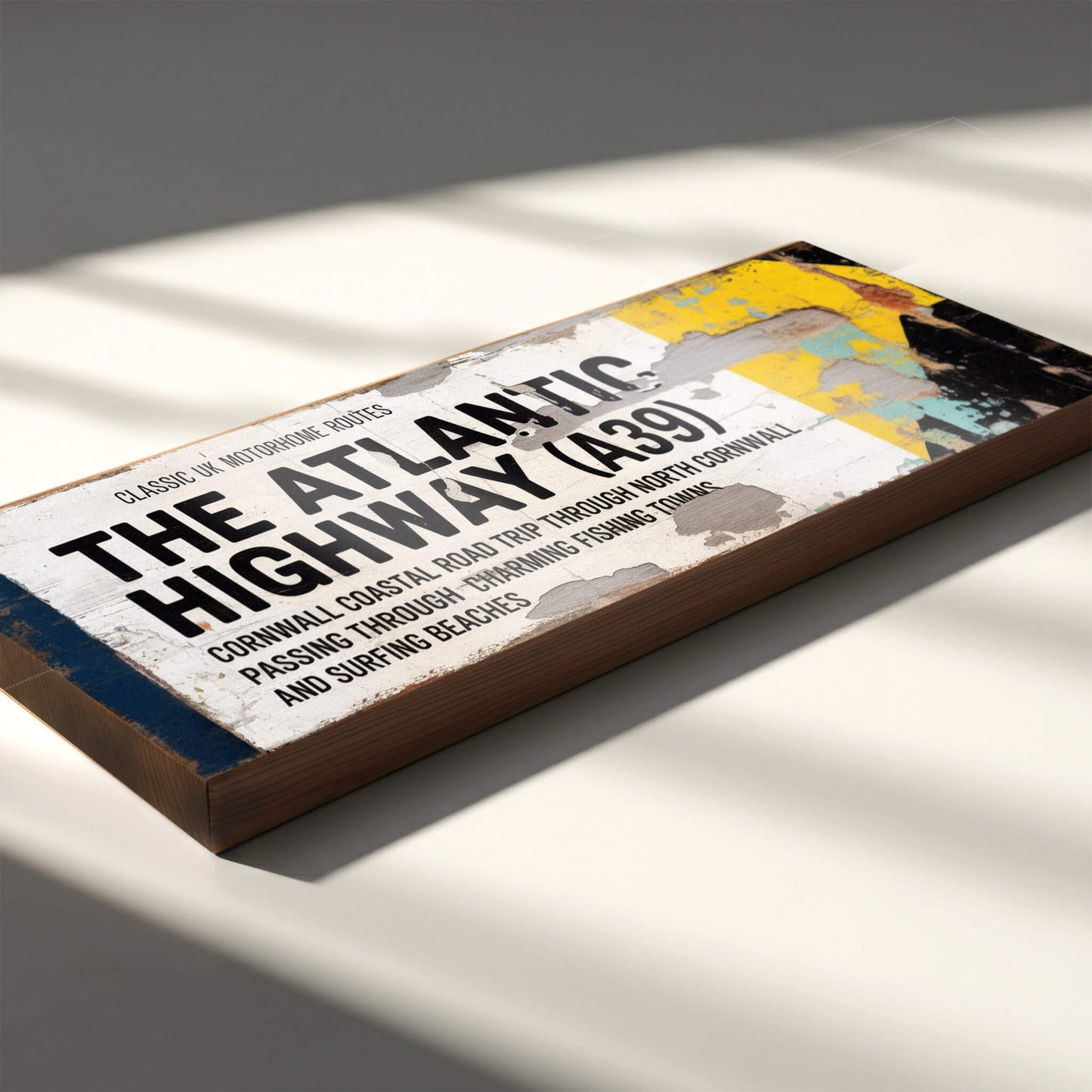 A rectangular vintage-style road sign on 18mm MDF for The Atlantic Highway A39. Features black text on a white background with a blue stripe, yellow arrow, and heavy integrated faux-rust and weathered paint effects.