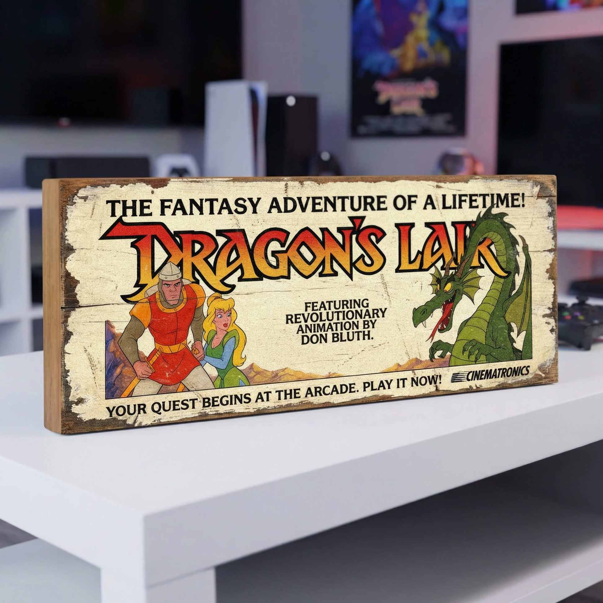 Dragon's Lair retro arcade game vintage wooden sign handmade on 18mm MDF with distressed cream finish featuring Dirk the Daring Princess Daphne and Singe the dragon, freestanding on white shelf in gaming room