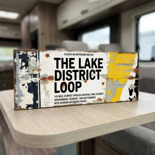 Rectangular vintage road sign for The Lake District Loop featuring Windermere and Keswick route details with a weathered retro aesthetic.