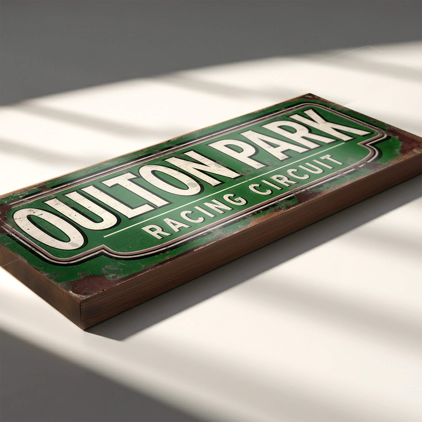 racing sign with "OULTON PARK RACING CIRCUIT" in cream letters on a green background. The design features heavy faux-rust and weathering effects.