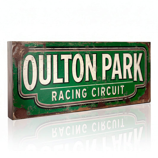 racing sign with "OULTON PARK RACING CIRCUIT" in cream letters on a green background. The design features heavy faux-rust and weathering effects.
