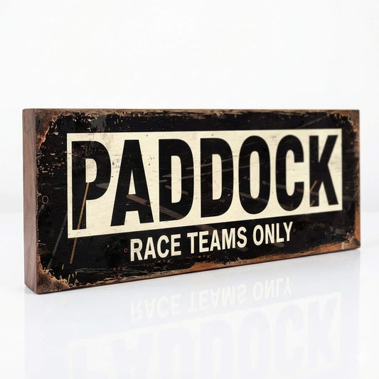 A rectangular black and cream sign with "PADDOCK RACE TEAMS ONLY" in bold text. The design features integrated faux-rust and heavy weathering effects on an 18mm MDF base.