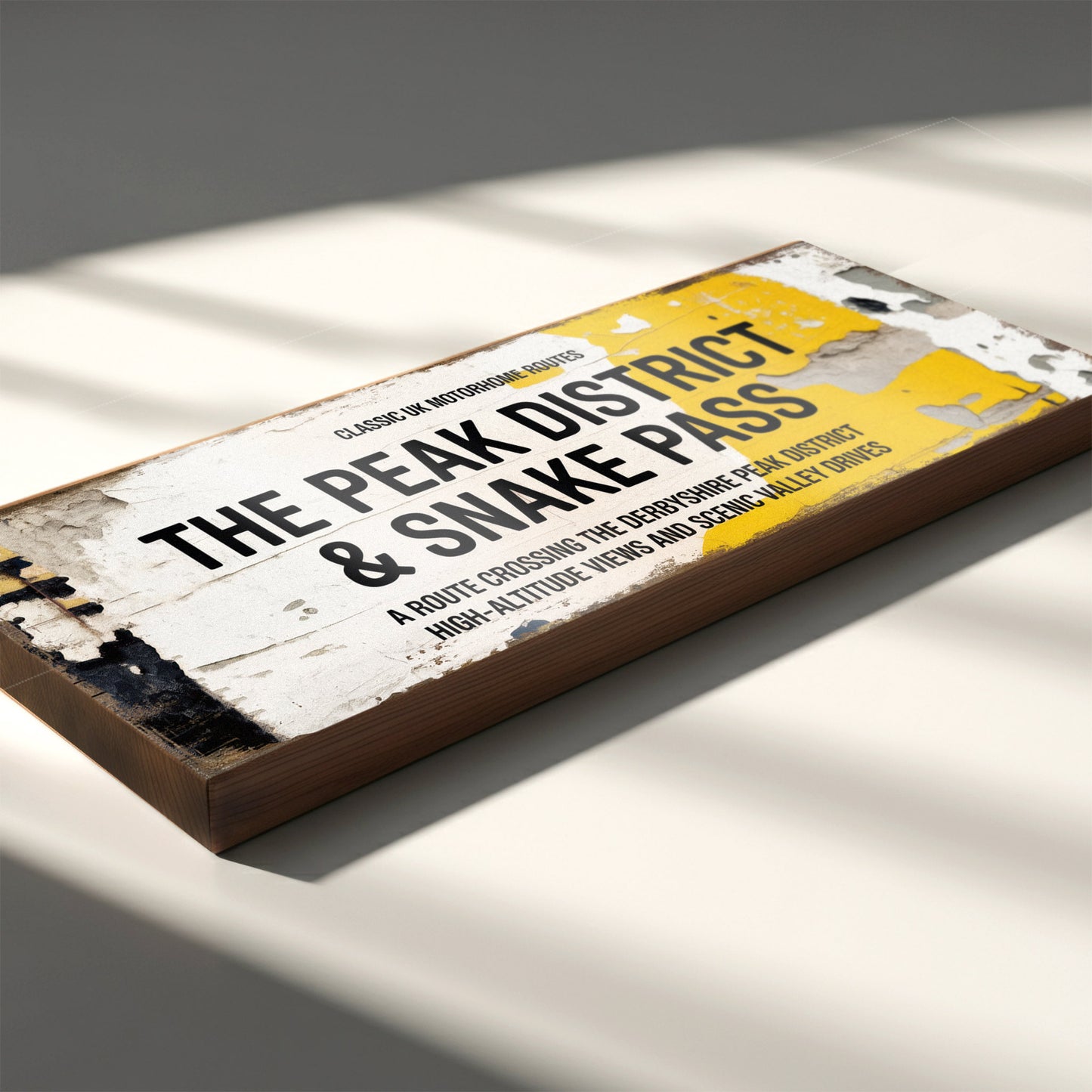 Rectangular vintage road sign for The Peak District and Snake Pass featuring high-altitude view details with a weathered retro aesthetic.