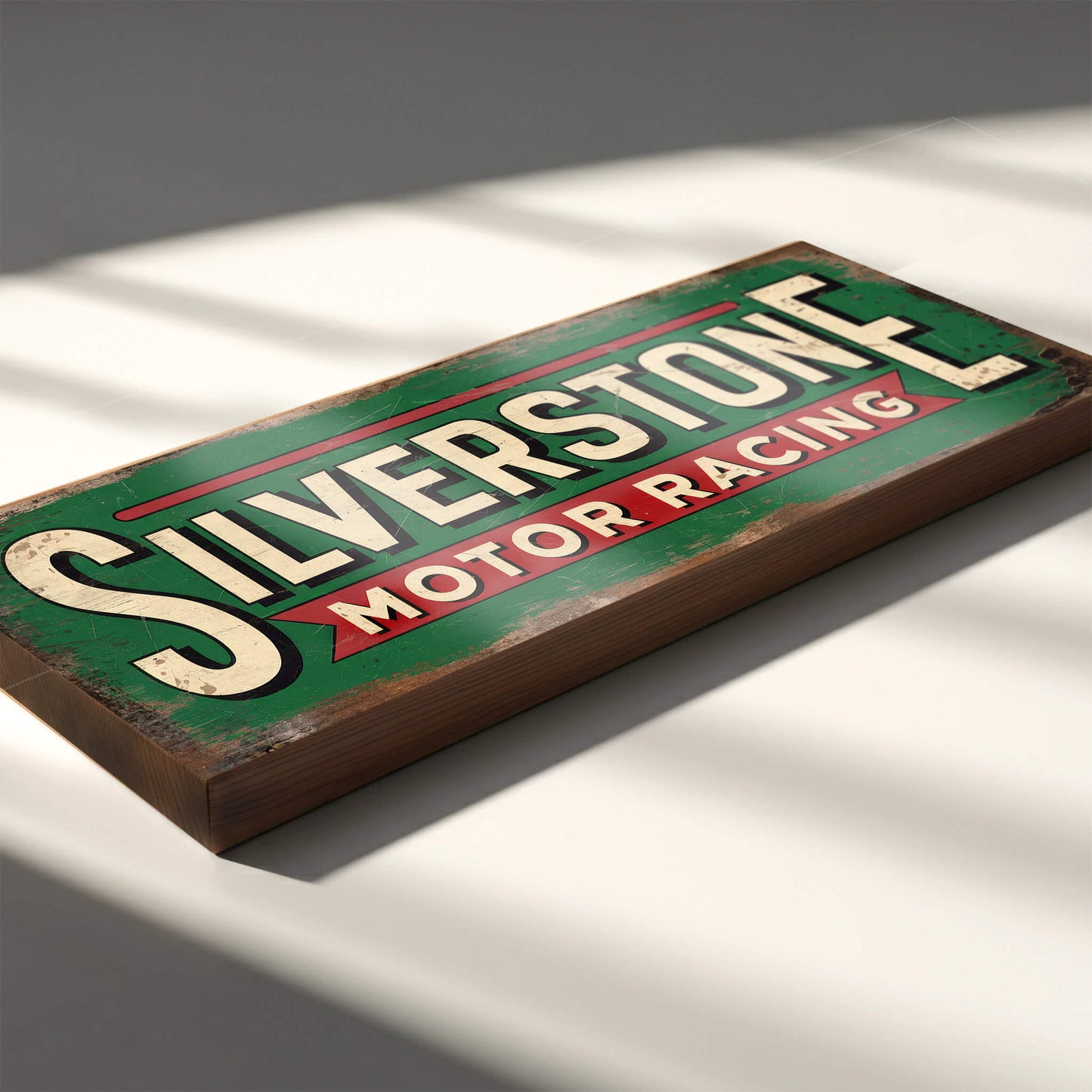 A rectangular racing sign on 18mm MDF with "SILVERSTONE MOTOR RACING" in cream and red over a green background. The design features heavy faux-rust and weathering effects.
